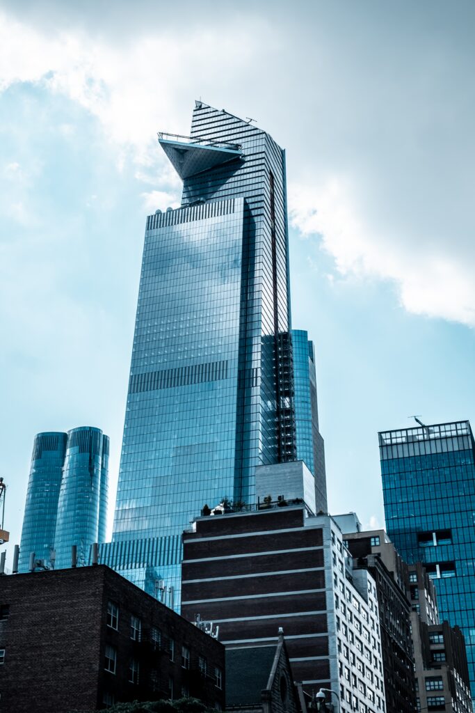 vertical low angle shot of modern glass business buildings touching the sky vertical low angle shot of modern glass business buildings touching the sky